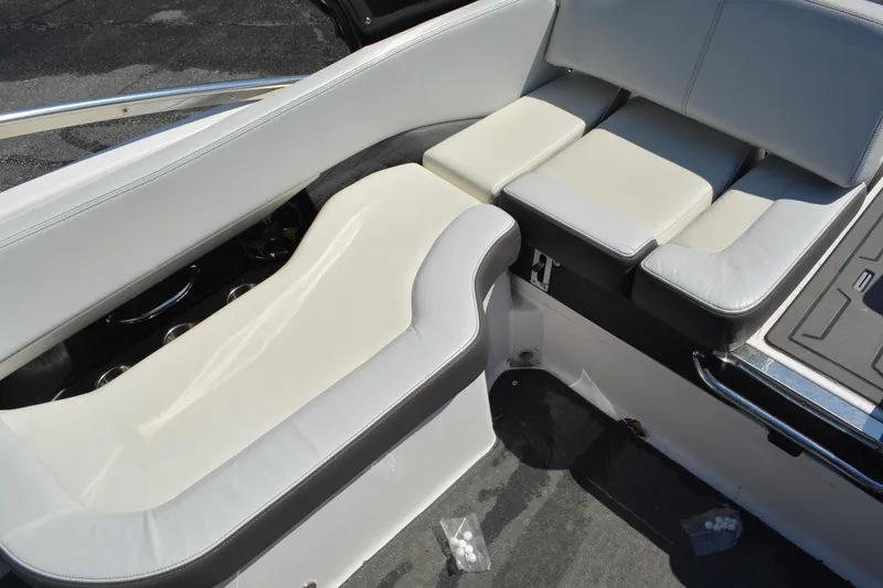 Slide: The Image of 2014 Regal 2300 Bowrider interior seating with white and gray upholstery. - 10