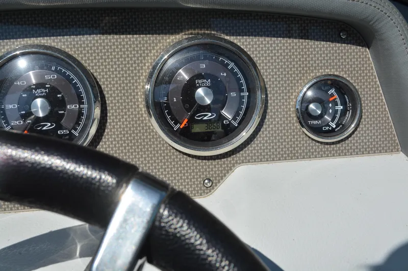 Slide: The Image of Dashboard of a 2014 Regal 2300 Bowrider showing speedometer, tachometer, and trim gauge. - 12