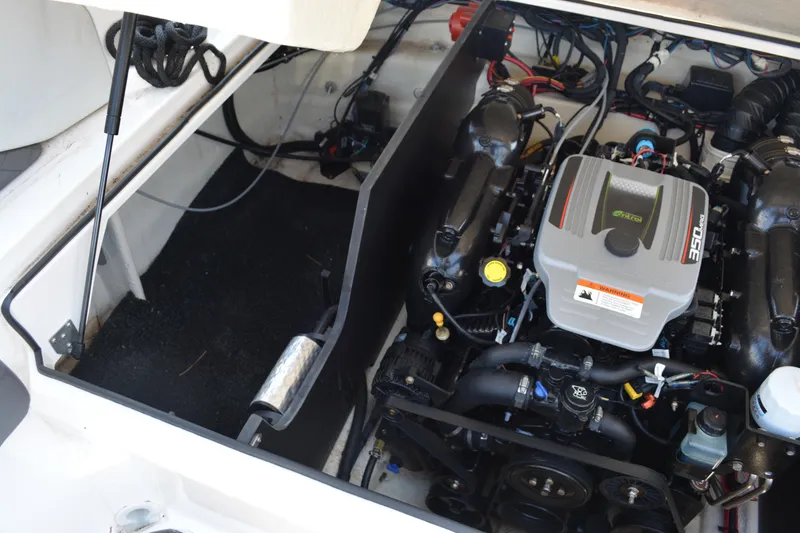Slide: The Image of Engine compartment of a 2014 Regal 2300 Bowrider boat, showcasing the 350 engine. - 13