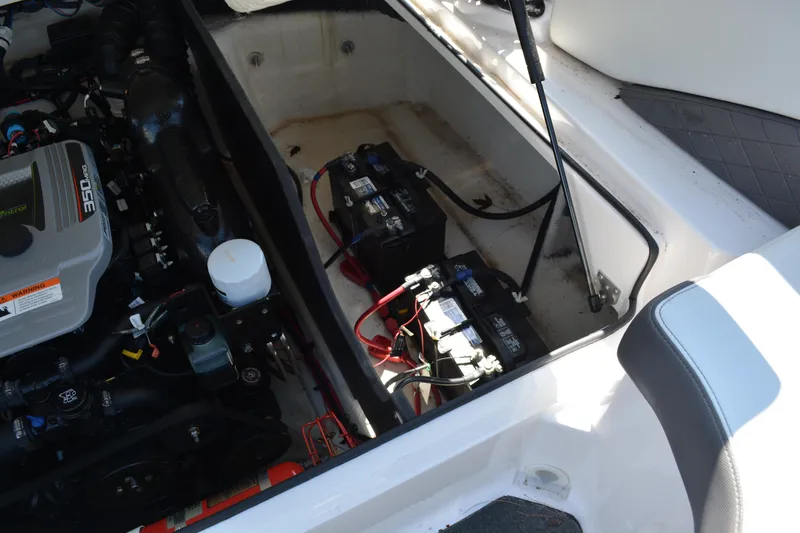 Slide: The Image of 2014 Regal 2300 Bowrider engine compartment with batteries and wiring visible. - 15