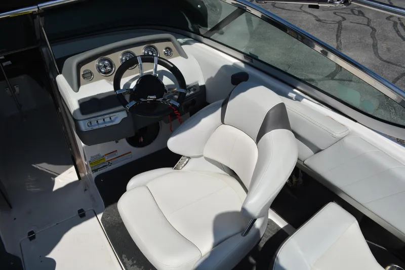 Slide: The Image of 2014 Regal 2300 Bowrider interior with steering wheel and white seating. - 7