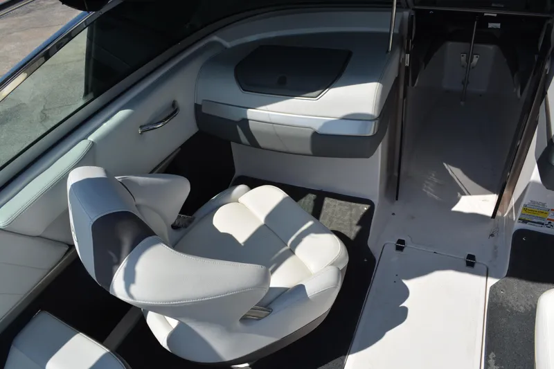 Slide: The Image of Interior of 2014 Regal 2300 Bowrider boat, featuring white seating and sleek design. - 8