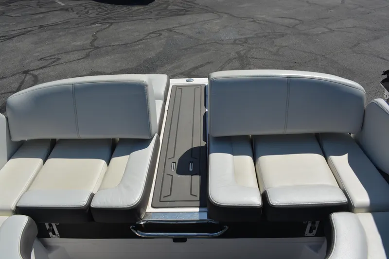 Slide: The Image of 2014 Regal 2300 Bowrider boat interior with white cushioned seating and sleek design. - 9