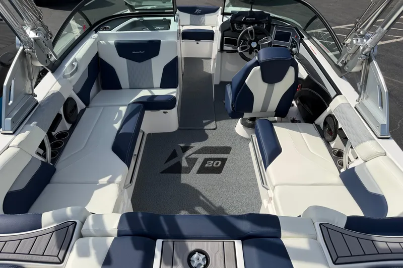 Slide: The Image of 2023 MasterCraft XT20 boat interior with luxurious seating and modern dashboard design. - 5