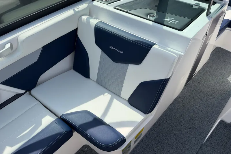 Slide: The Image of 2023 MasterCraft XT20 boat interior with stylish blue and white seating. - 6
