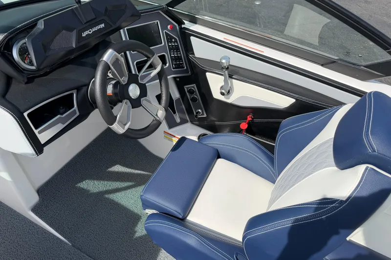 Slide: The Image of 2023 MasterCraft XT20 boat interior with modern steering wheel and blue-white seating. - 8