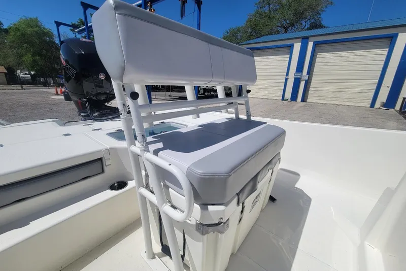 Slide: The Image of 2025 Mako Pro Skiff 19 CC boat interior with cushioned seating and storage. - 11