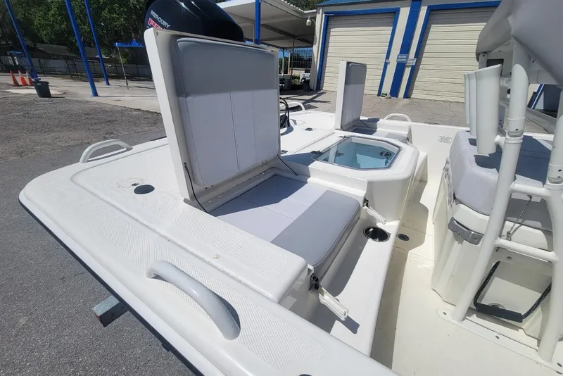 Slide: The Image of 2025 Mako Pro Skiff 19 CC boat interior with seating and storage compartments. - 13