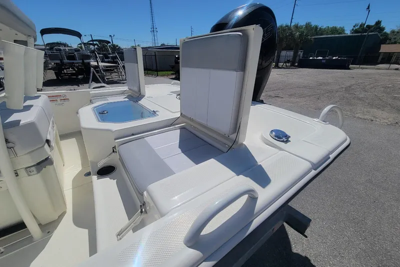 Slide: The Image of 2025 Mako Pro Skiff 19 CC boat interior with seating and storage features. - 16