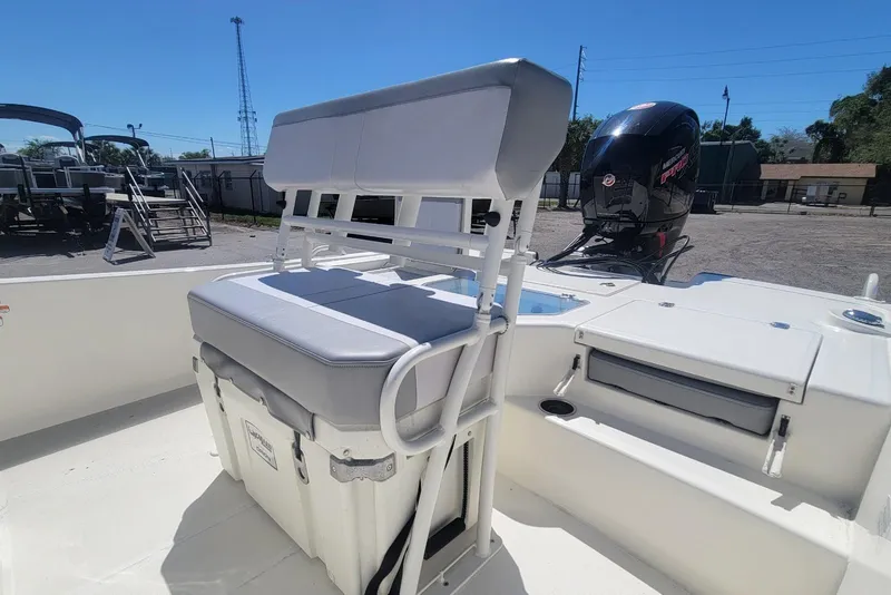Slide: The Image of 2025 Mako Pro Skiff 19 CC boat interior with seating and outboard motor. - 17