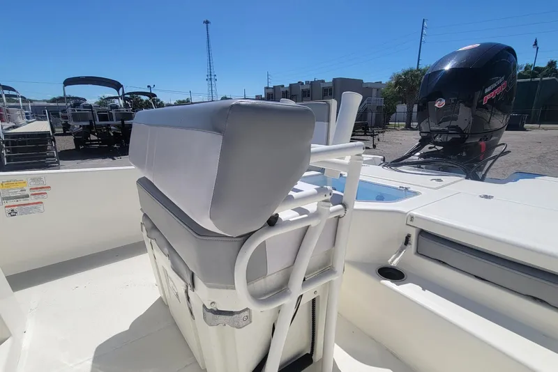 Slide: The Image of 2025 Mako Pro Skiff 19 CC boat interior with seating and outboard motor. - 18