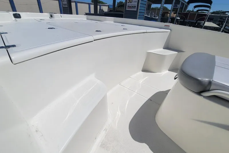 Slide: The Image of 2025 Mako Pro Skiff 19 CC boat interior with seating and storage compartments. - 21