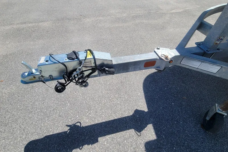 Slide: The Image of Trailer hitch of a 2025 Mako Pro Skiff 19 CC on asphalt surface. - 22