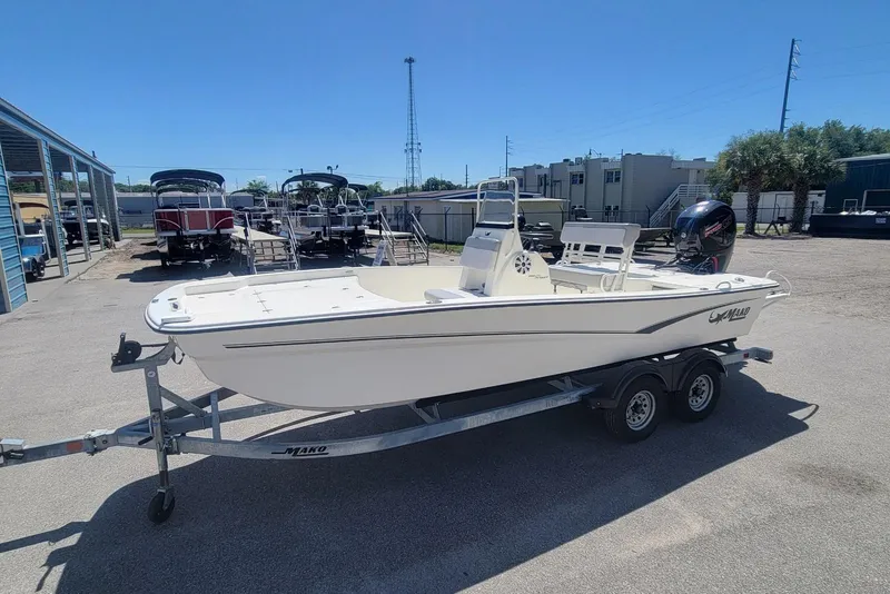 Slide: The Image of 2025 Mako Pro Skiff 19 CC boat on trailer in outdoor lot. - 5