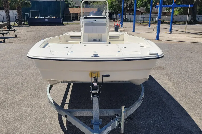 Slide: The Image of 2025 Mako Pro Skiff 19 CC boat on trailer in outdoor setting. - 6