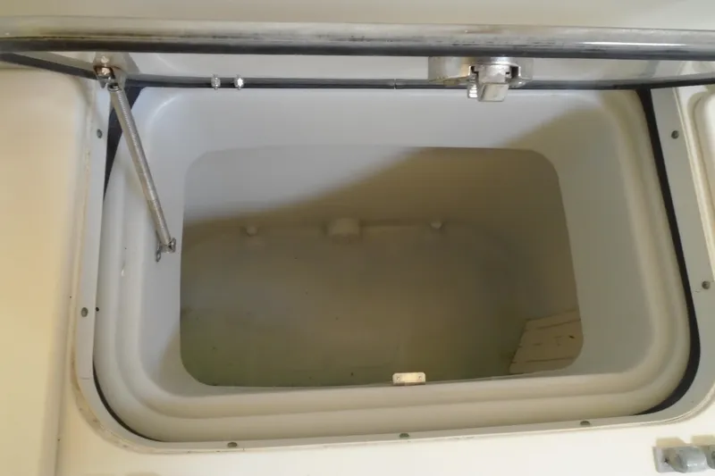 Slide: The Image of Open storage compartment on a 2004 Hydra-Sports Vector 3300 CC boat. - 15