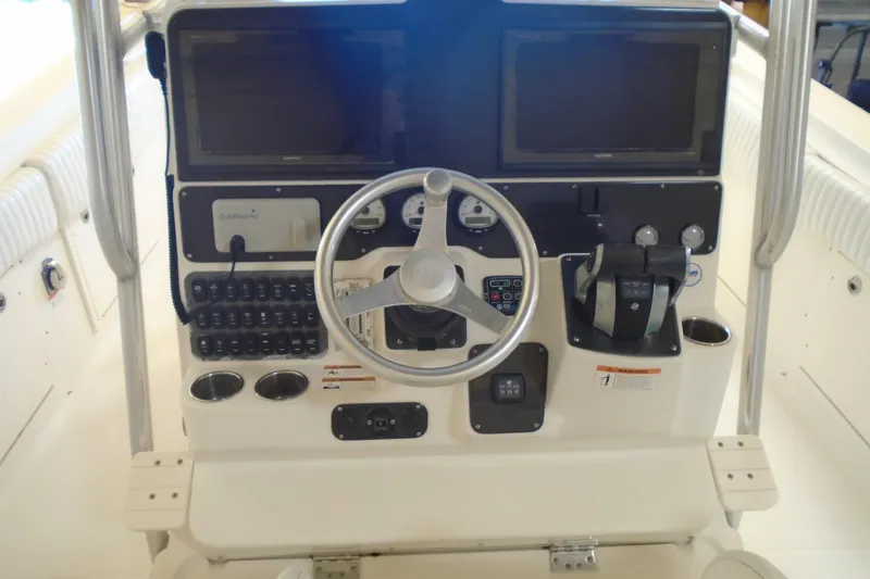 Slide: The Image of 2004 Hydra-Sports Vector 3300 CC boat dashboard with steering wheel and controls. - 16