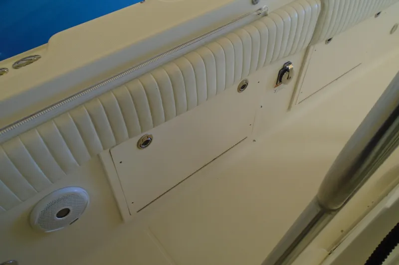 Slide: The Image of Interior view of a 2004 Hydra-Sports Vector 3300 CC boat, featuring padded seating and storage compartments. - 17