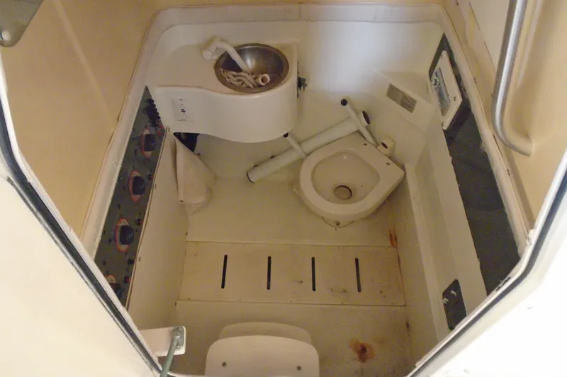 Slide: The Image of 2004 Hydra-Sports Vector 3300 CC boat bathroom with compact sink and toilet. - 18