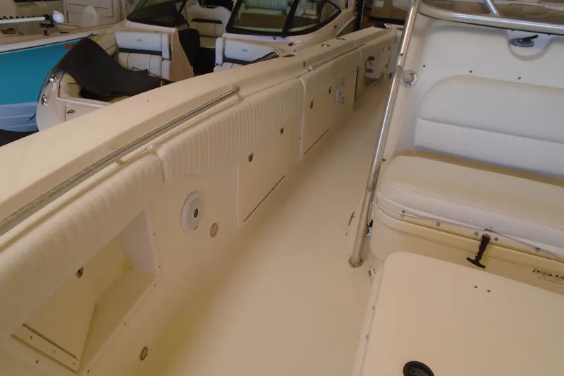 Slide: The Image of 2004 Hydra-Sports Vector 3300 CC boat interior with white seating and storage compartments. - 22
