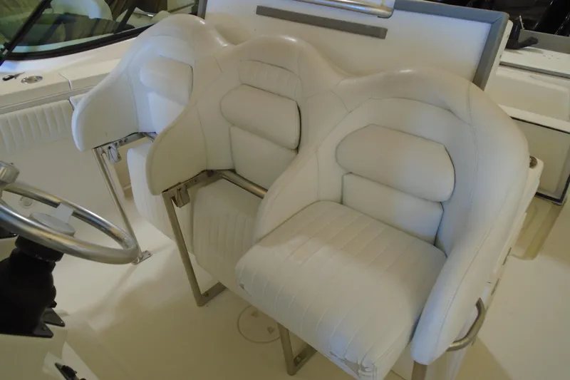 Slide: The Image of 2004 Hydra-Sports Vector 3300 CC boat interior with white cushioned seats and steering wheel. - 25