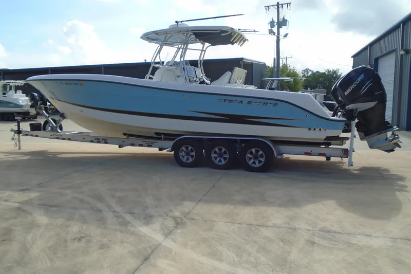Slide: The Image of 2004 Hydra-Sports Vector 3300 CC boat on trailer, parked outdoors near a warehouse. - 8