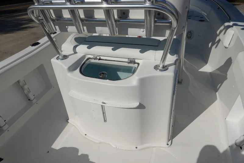 Slide: The Image of 2014 Sea Hunt Ultra 225 boat interior with livewell and rod holders. - 11