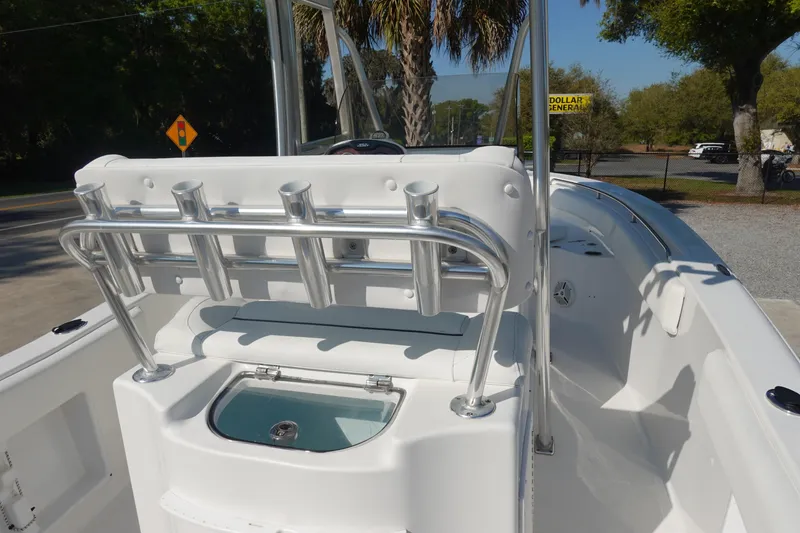 Slide: The Image of 2014 Sea Hunt Ultra 225 boat interior with rod holders and seating. - 12