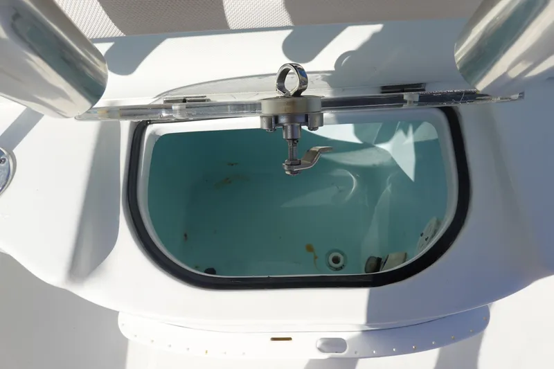 Slide: The Image of Livewell compartment on a 2014 Sea Hunt Ultra 225 boat, open lid view. - 14
