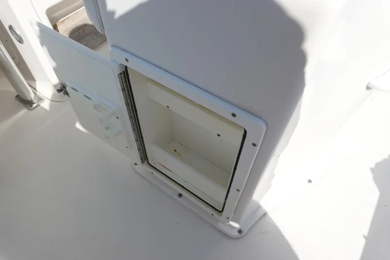 Slide: The Image of Open storage compartment on a 2014 Sea Hunt Ultra 225 boat deck. - 15
