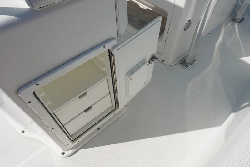 Slide: The Image of Open storage compartment on 2014 Sea Hunt Ultra 225 boat deck. - 16