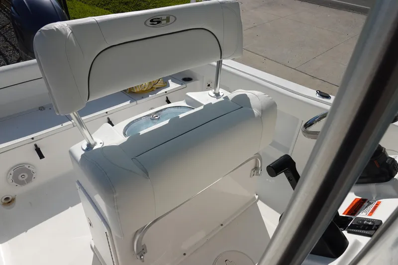 Slide: The Image of 2014 Sea Hunt Ultra 225 boat interior with white seating and control panel. - 17