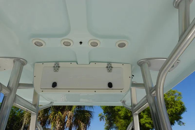 Slide: The Image of 2014 Sea Hunt Ultra 225 boat T-top with integrated lights and storage compartment. - 20