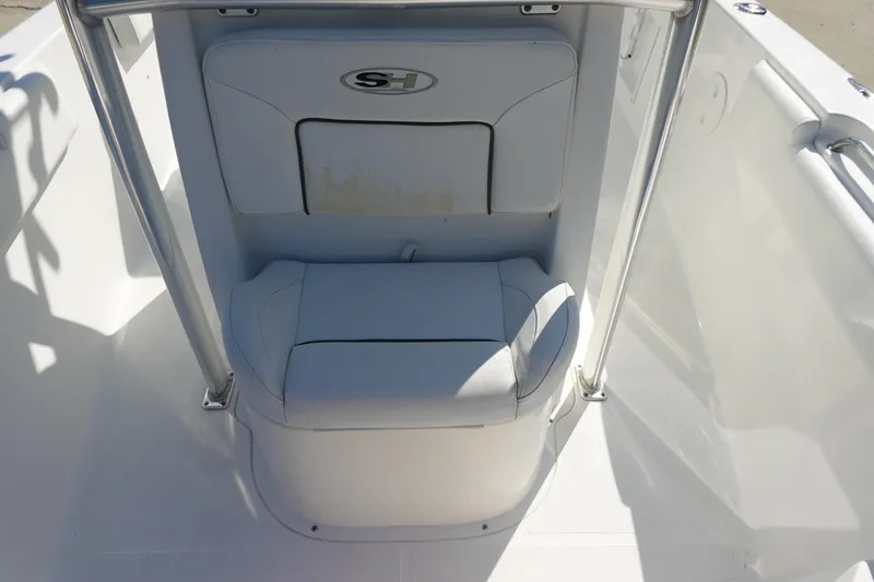 Slide: The Image of 2014 Sea Hunt Ultra 225 boat seating area with white upholstery and metal railings. - 22