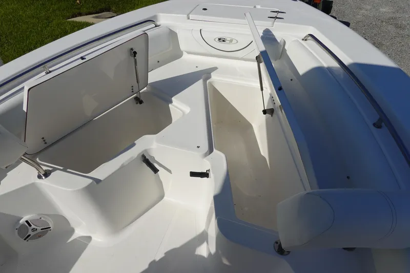 Slide: The Image of 2014 Sea Hunt Ultra 225 boat interior with open storage compartments. - 26