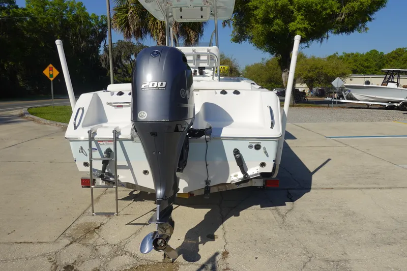 Slide: The Image of 2014 Sea Hunt Ultra 225 boat with Yamaha 200 engine, parked outdoors. - 5
