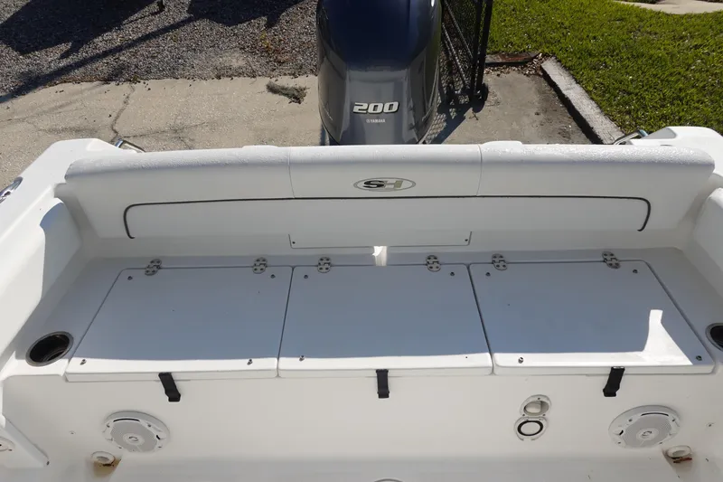 Slide: The Image of 2014 Sea Hunt Ultra 225 boat interior with Yamaha 200 engine, featuring storage compartments. - 8
