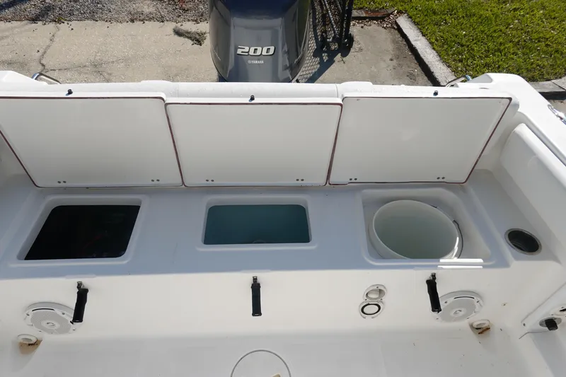 Slide: The Image of 2014 Sea Hunt Ultra 225 boat deck with storage compartments and Yamaha 200 engine. - 9