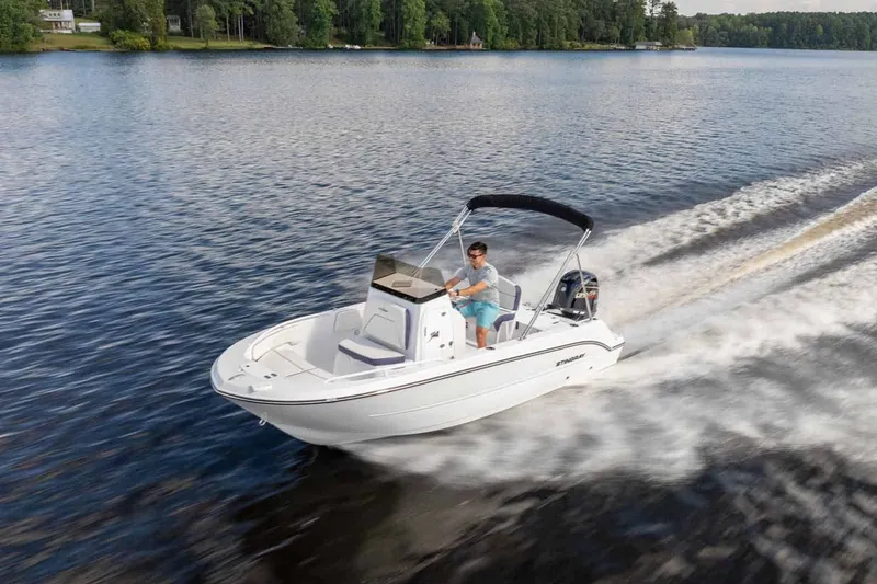 Slide: The Image of 2026 Stingray 173 CC boat cruising on a serene lake. - 13