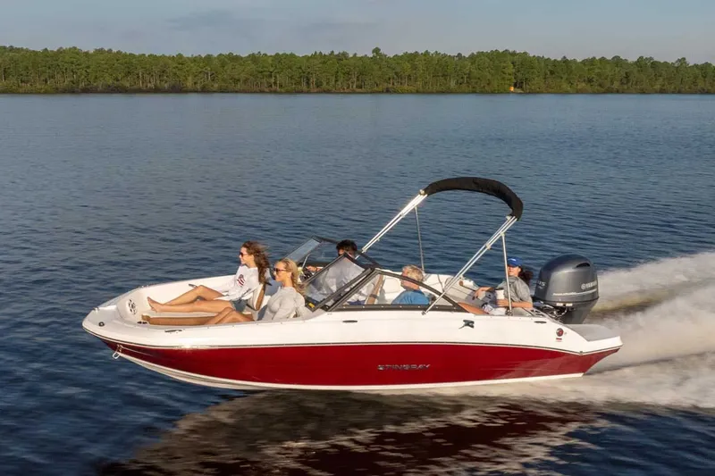 Slide: The Image of 2026 Stingray 191 DC boat cruising on a serene lake. - 15