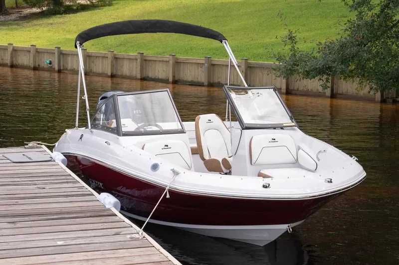 Slide: The Image of 2026 Stingray 191 DC boat docked on calm water. - 18