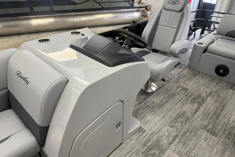 Slide: The Image of 2026 Bentley Pontoons Legacy 243 Swingback interior with sleek gray seating and modern console design. - 4