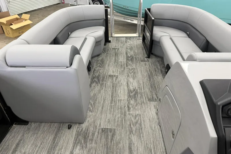Slide: The Image of Interior of 2026 Bentley Pontoons Legacy 243 Swingback with gray seating and wood-style flooring. - 7