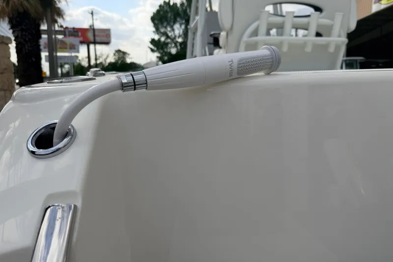 Slide: The Image of Close-up of a 2026 Pathfinder 2400 TRS boat's deck with a white hose attachment. - 13
