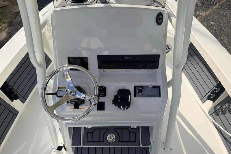 Slide: The Image of 2026 Pathfinder 2400 TRS boat console with steering wheel and control panel. - 15