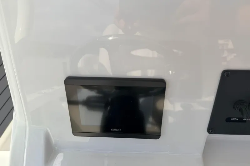 Slide: The Image of Yamaha display on 2026 Pathfinder 2400 TRS boat dashboard with control panel. - 18