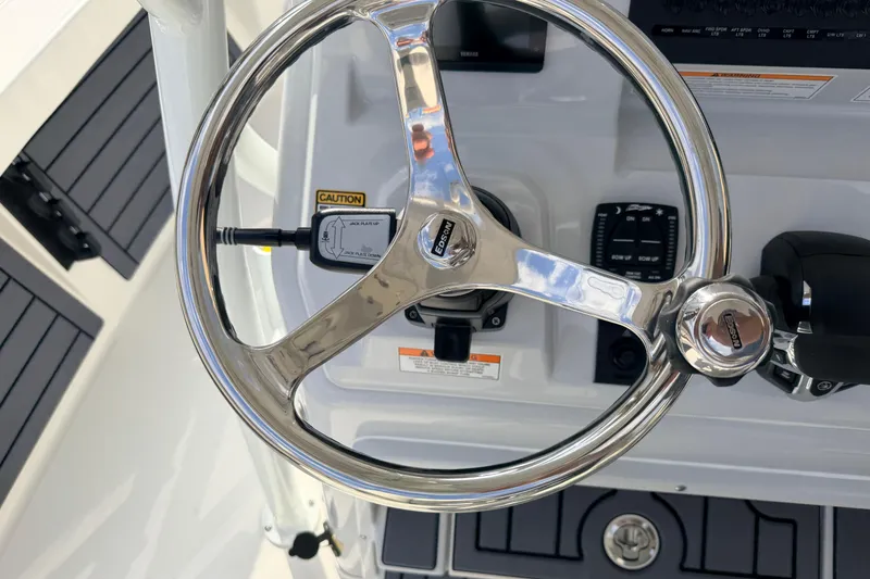 Slide: The Image of Steering wheel of 2026 Pathfinder 2400 TRS boat, featuring modern controls and sleek design. - 19