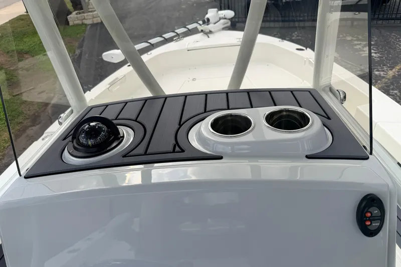Slide: The Image of 2026 Pathfinder 2400 TRS boat console with compass and cup holders. - 22