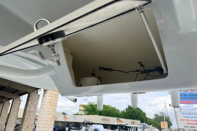 Slide: The Image of Open compartment of a 2026 Pathfinder 2400 TRS boat, showing interior wiring and components. - 28