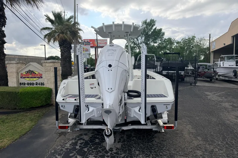 Slide: The Image of 2026 Pathfinder 2400 TRS boat on trailer, parked outdoors near dealership. - 3